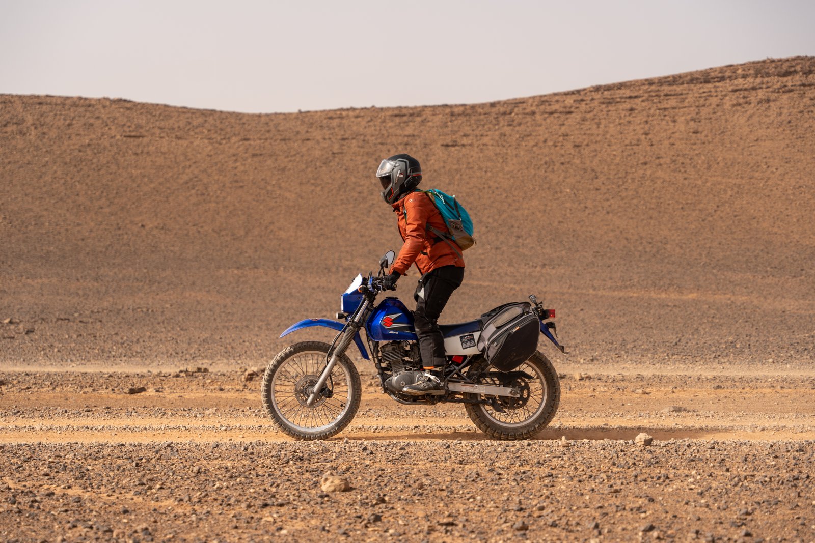 Rider standing on the pegs crossing the Moroccan desert